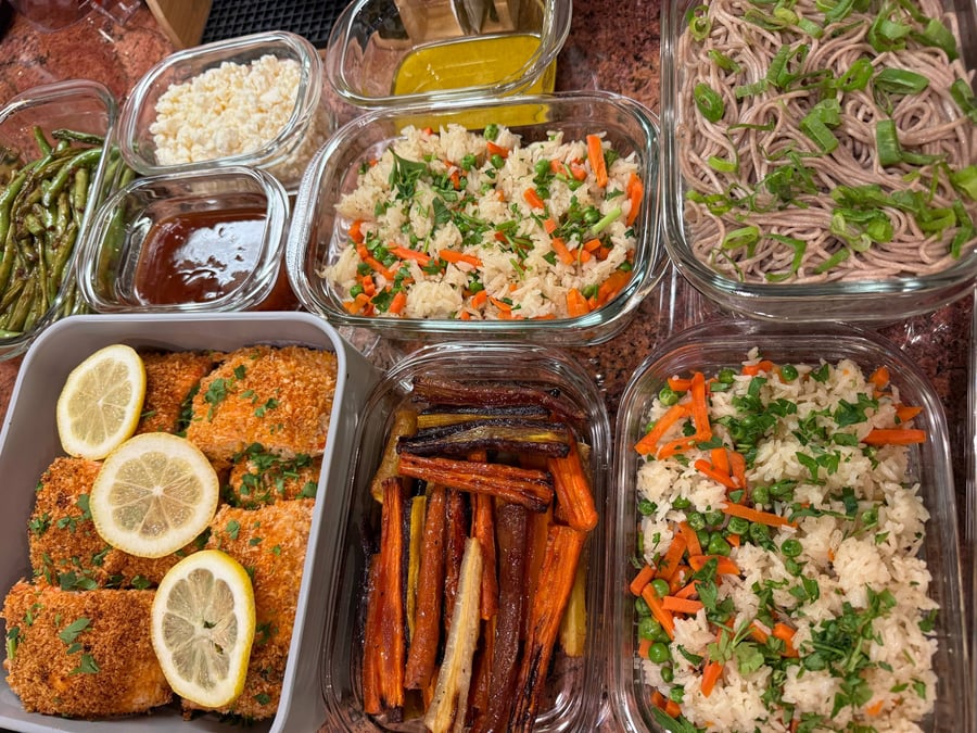 Honey roasted rainbow carrots darken at the tips beside panko salmon, basmati rice with peas, and soba noodles.