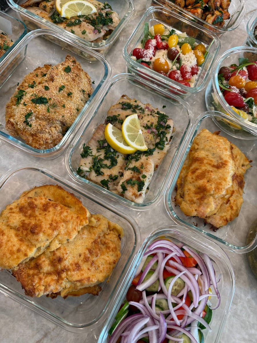 Two lemon wheels and chopped herbs cover flounder over butter beans, crusted chicken filling the corners.