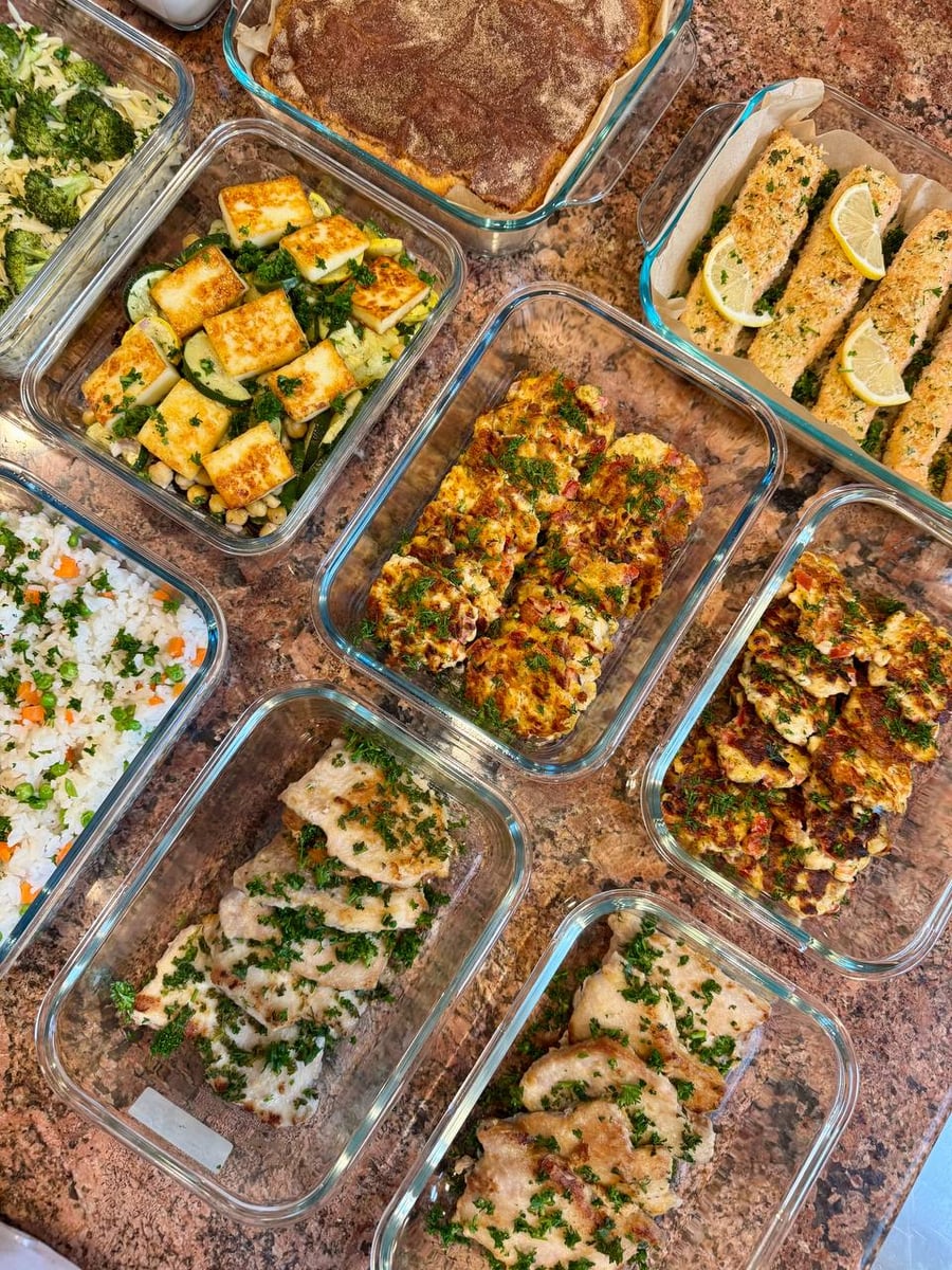 Lemon garlic pork chops sit under chopped parsley beside cubed halloumi, zucchini coins and chickpeas.