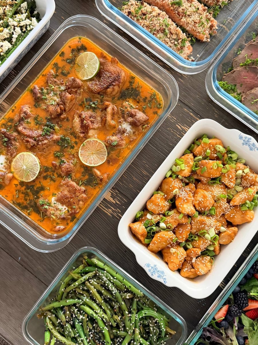Sesame and scallions over the orange glazed chicken bites, green beans and coconut chicken flanking them.
