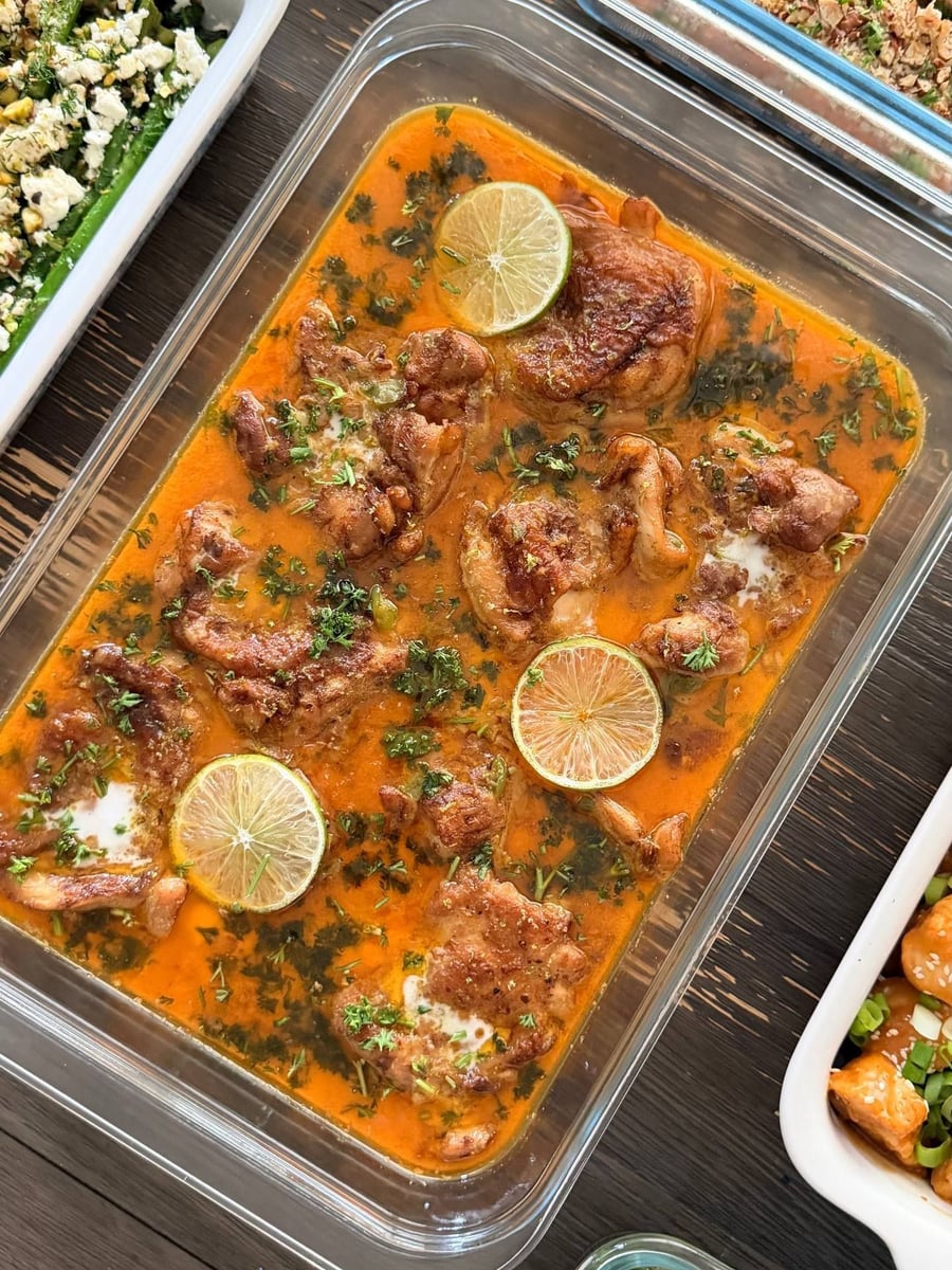 Lime wheels float in the orange coconut sauce around the Thai chicken thighs, parsley scattered across.