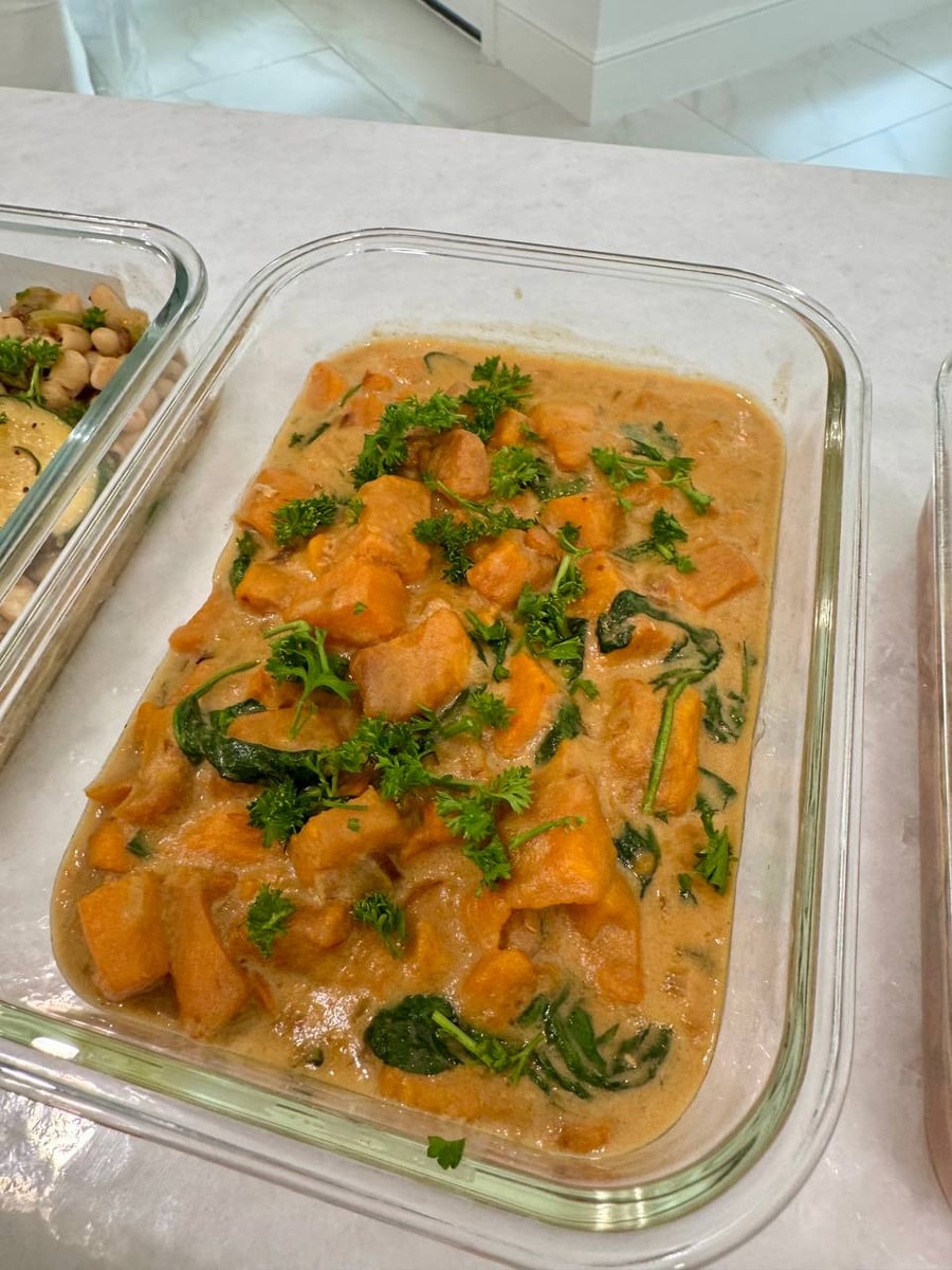 Spinach leaves surface in the gingered sweet potato stew, parsley torn over its creamy sauce.