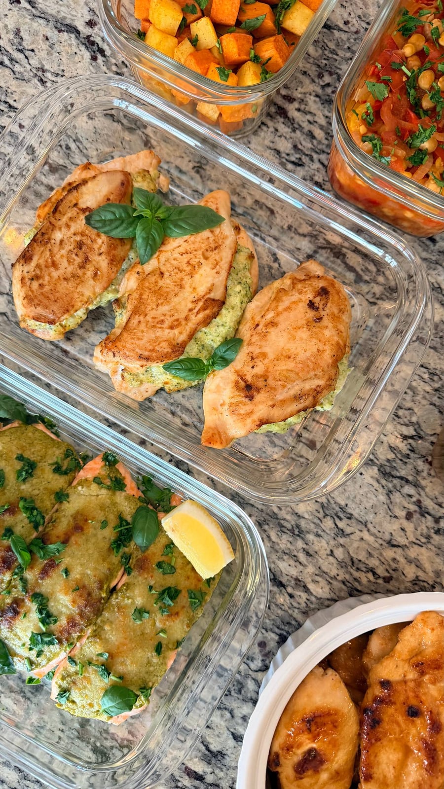 Basil crowns three chicken roulades split open on a pale green cheese filling, pesto salmon underneath.