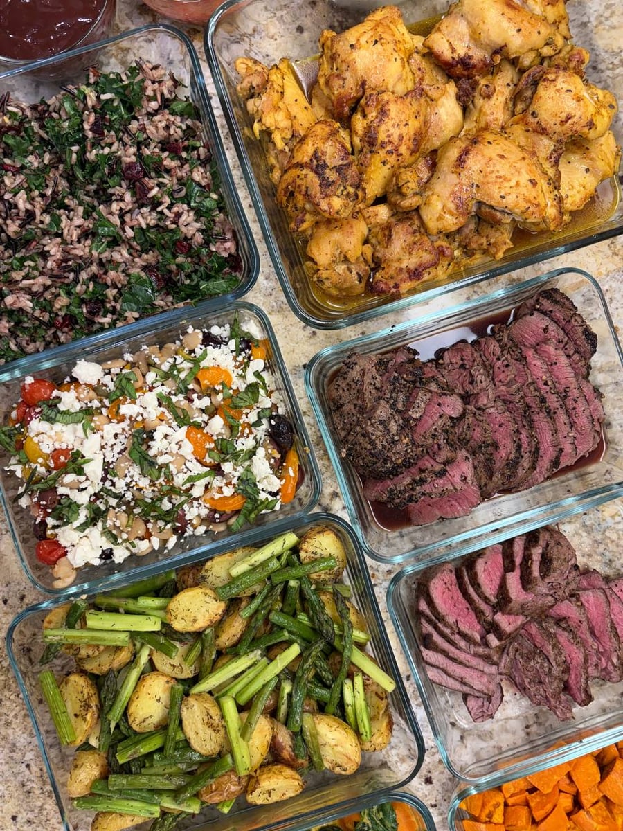 Cranberries and shredded kale run through wild rice, with shawerma thighs and feta-topped butter beans alongside.