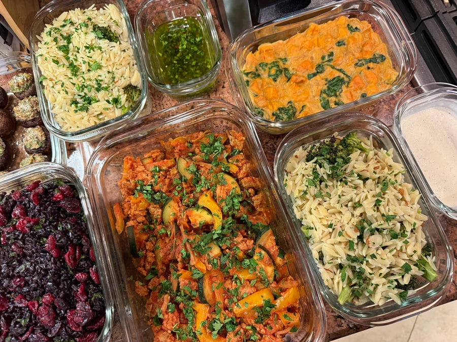 Spinach threads through the gingered sweet potato stew, ground turkey and a herb sauce cup beside it.