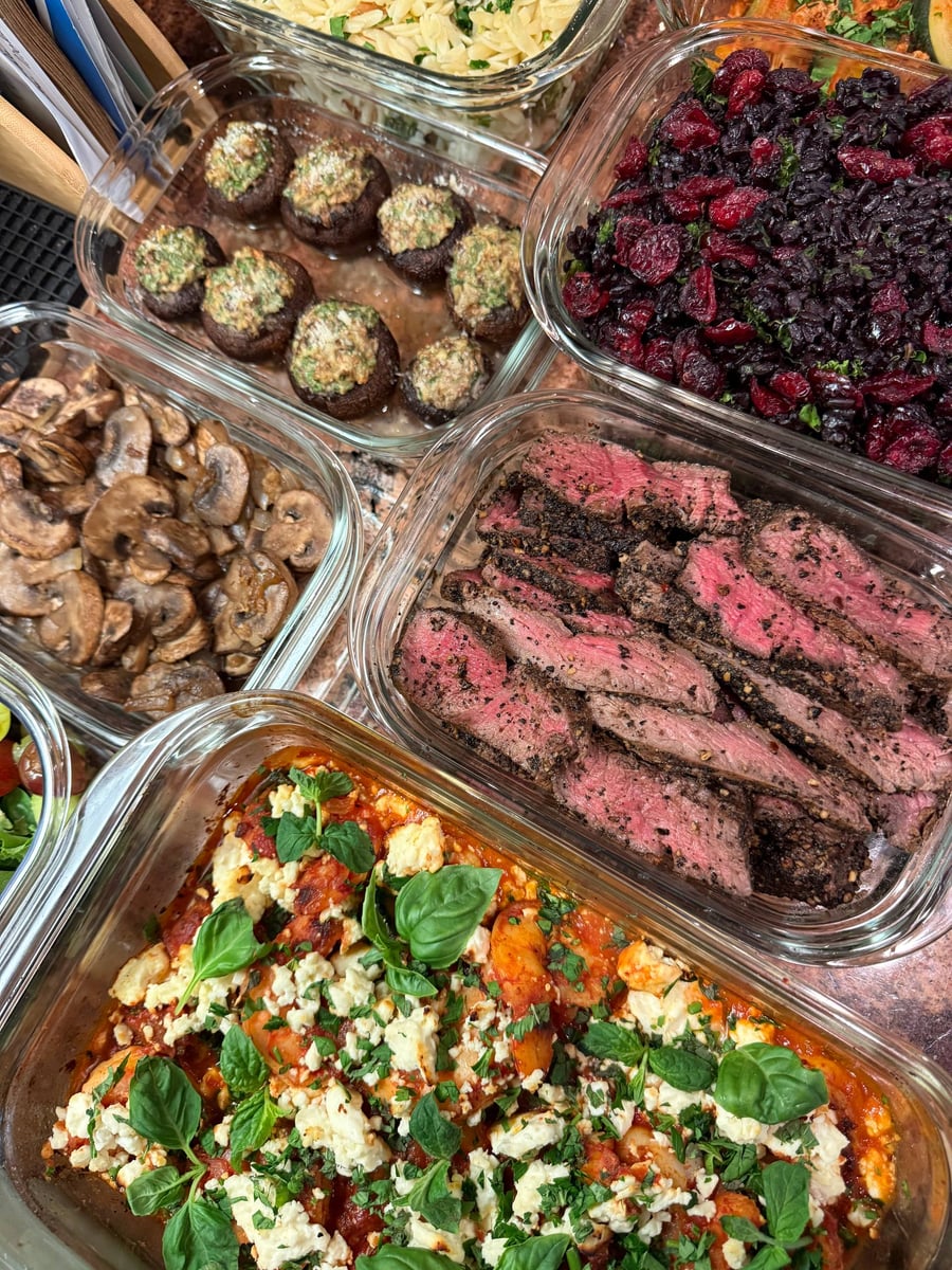 Cranberries sit bright red against the near black kale wild rice, filet and mushrooms alongside.