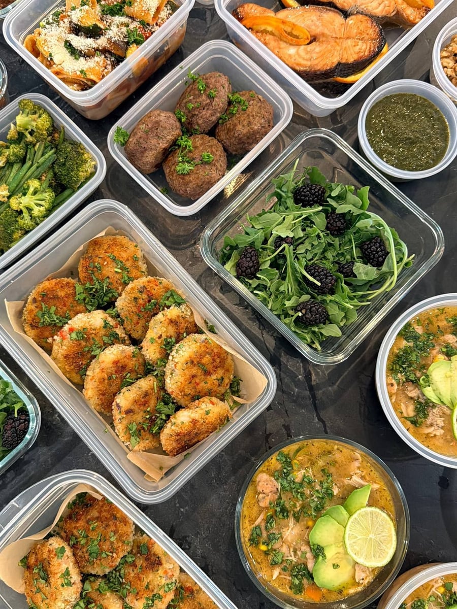 Blackberries sit whole on arugula beside Thai shrimp cakes and a cup of green cilantro chutney.