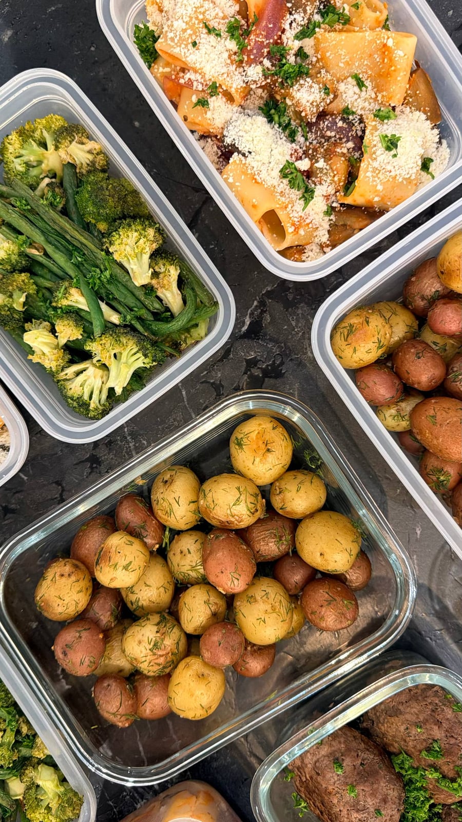 Golden shrimp cakes rest on parchment, cilantro through the crumb, beefsteaks and dill potatoes around them.