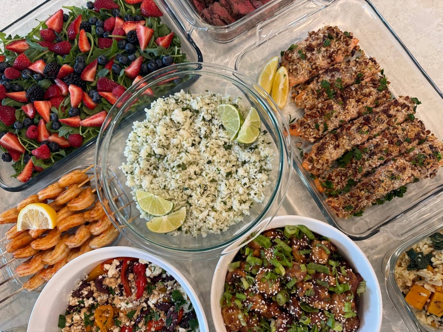 Strawberries, blueberries and blackberries scatter across arugula, pecan salmon and cilantro rice alongside.