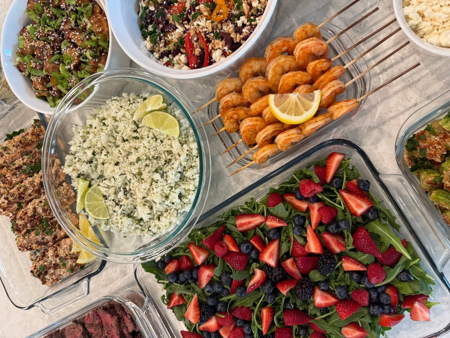 Butternut cubes and dark kale ribbons run through orzo, olives and feta piled in the bowl above.