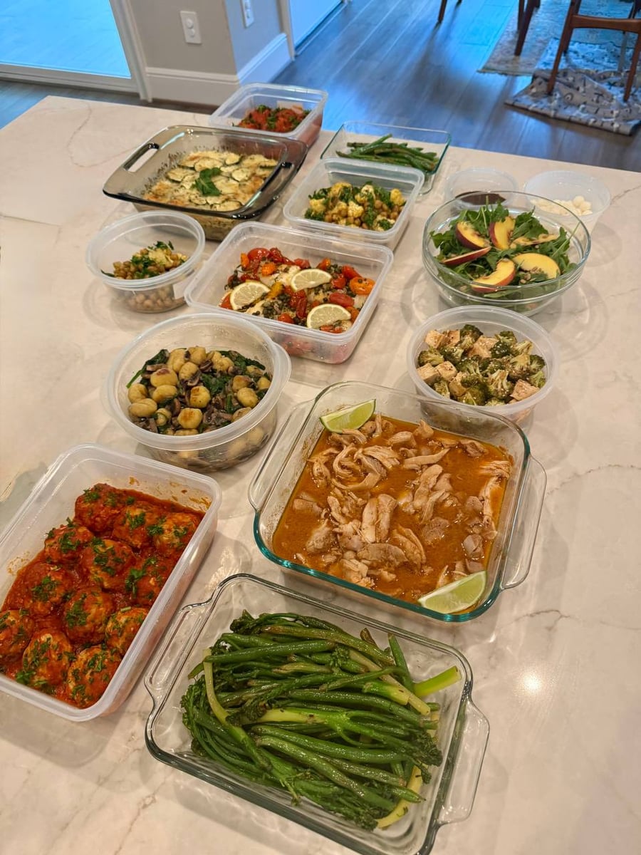 Shredded chicken swims in its own broth beside broccolini, meatballs and a browned potato zucchini gratin.