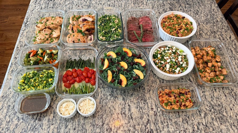 Dark balsamic glaze coats the salmon bites under torn parsley, corn couscous and spanish rice above.