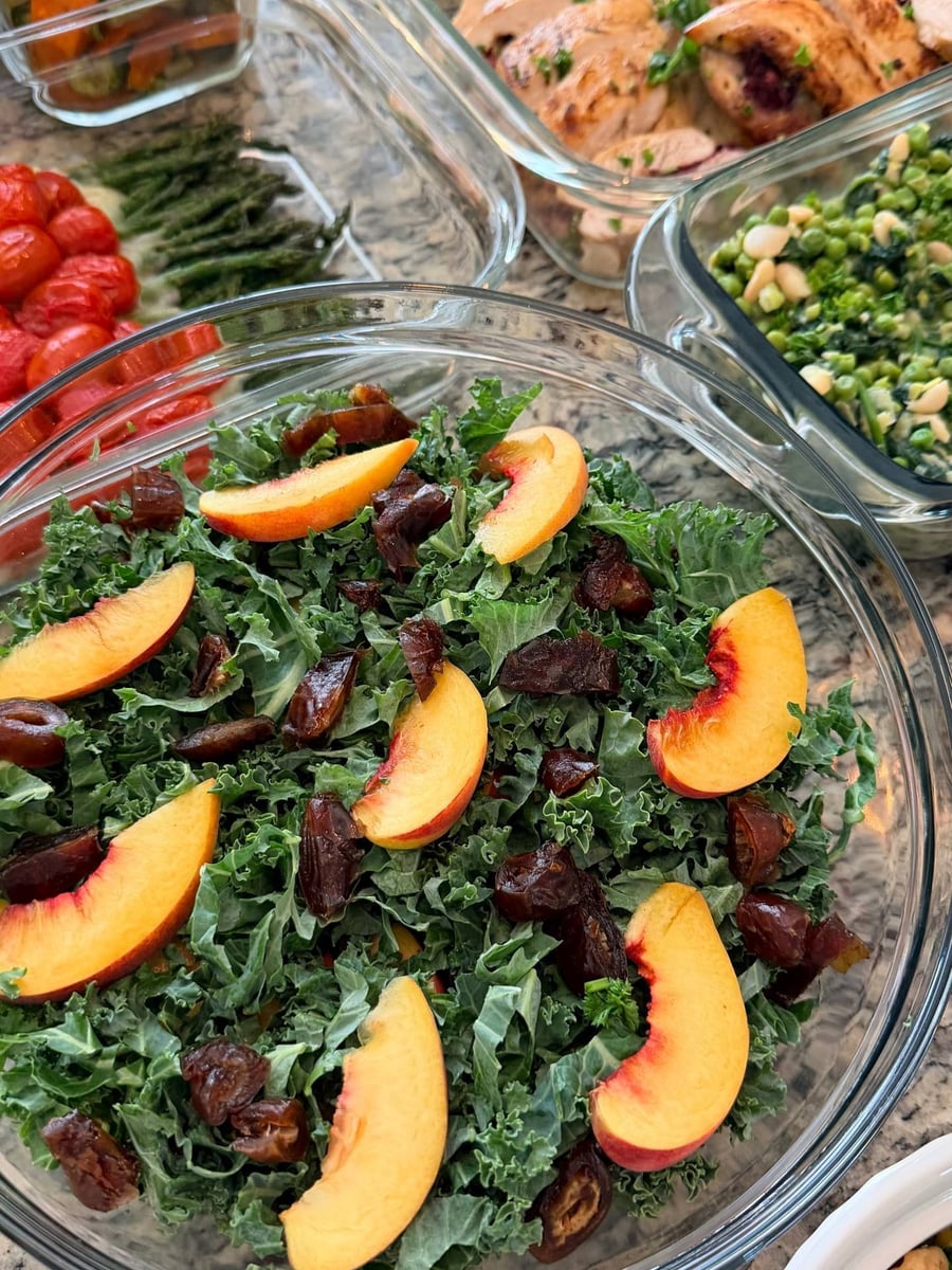 Feta and walnuts drop over the charred corn couscous, kale salad and rosemary filet sharing the frame.