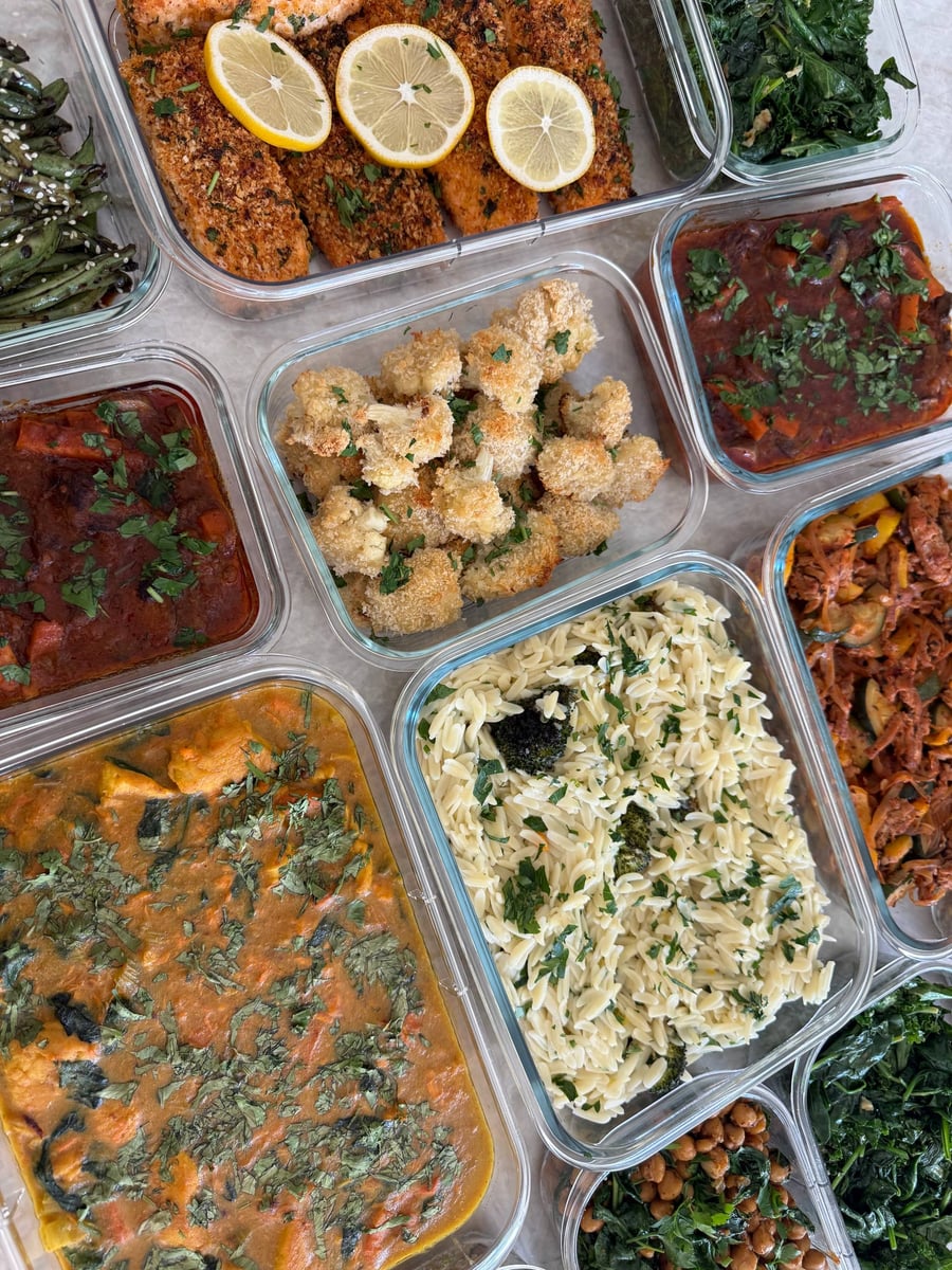 Turmeric turns the chicken veggie stew deep gold, cilantro across the surface, charred corn quinoa to the right.