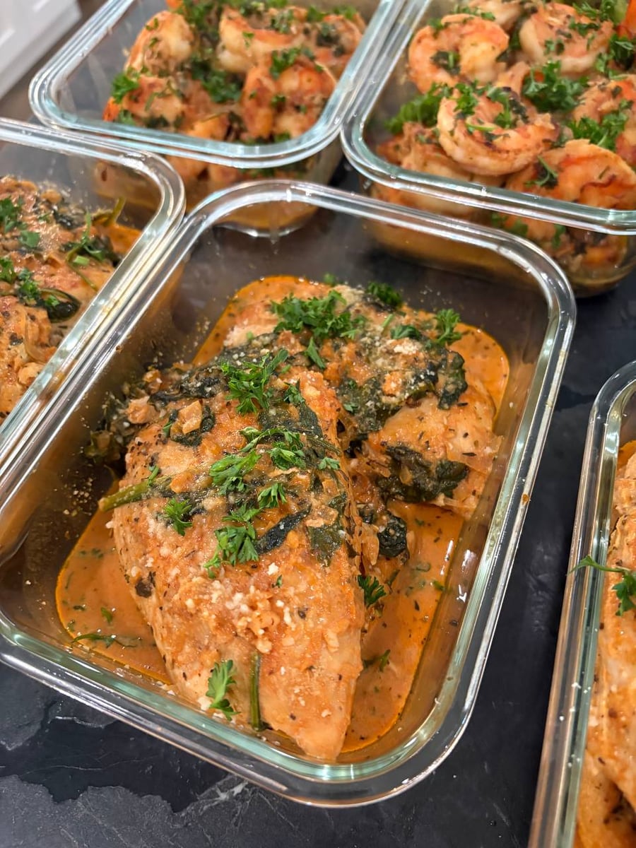 Parmesan and wilted spinach ride the creamy tuscan chicken, shrimp scampi stacked in the trays above.