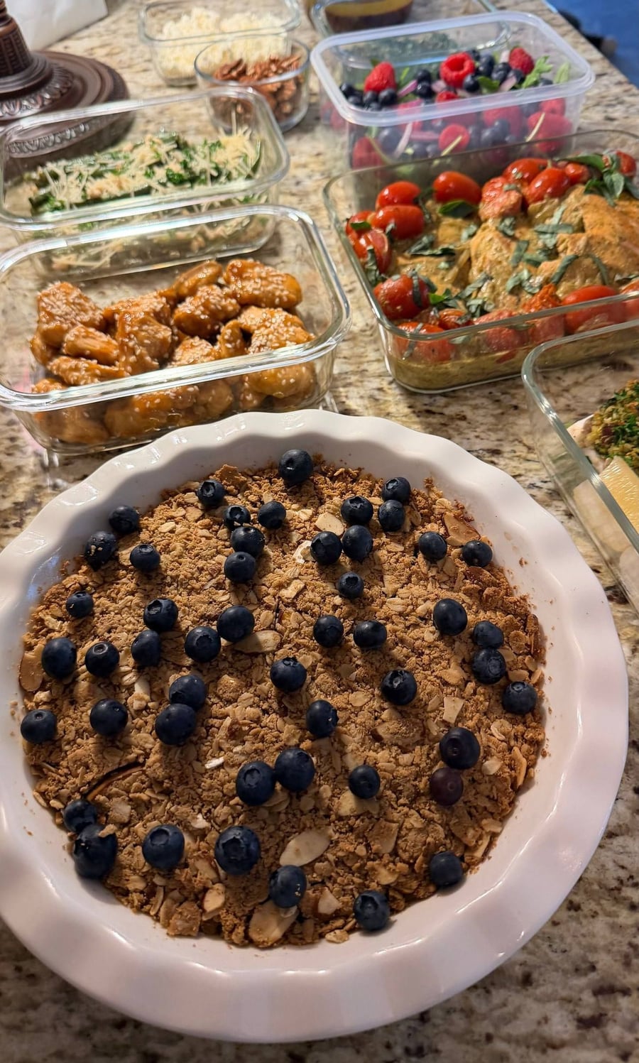 Almond peach cobbler anchors the counter, with chimichurri, pecans, feta and balsamic waiting in their own jars.