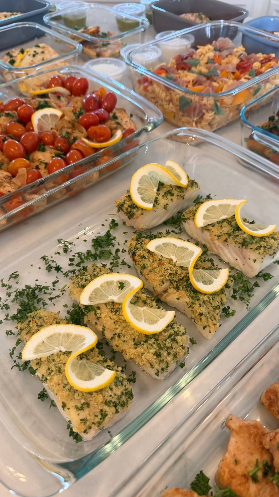 Lemon twists curl over the herb crusted halibut, chopped parsley scattered right across the dish.