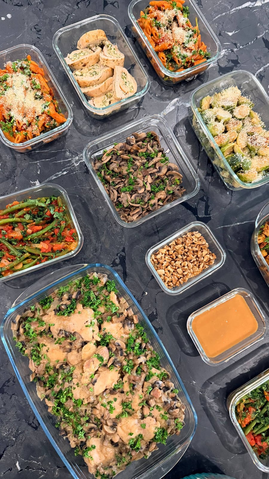 Chicken Marsala in a mushroom cream, parsley scattered heavily across the whole tray.