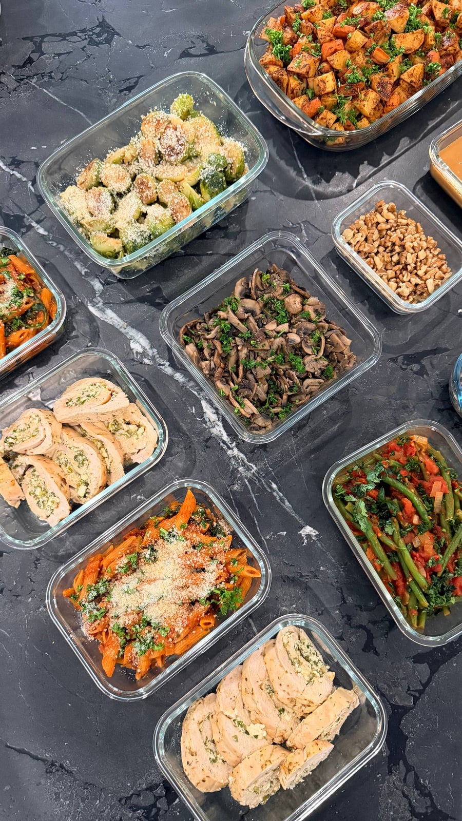 Roulade slices showing a green herb and feta spiral, next to penne in tomato and mushrooms.
