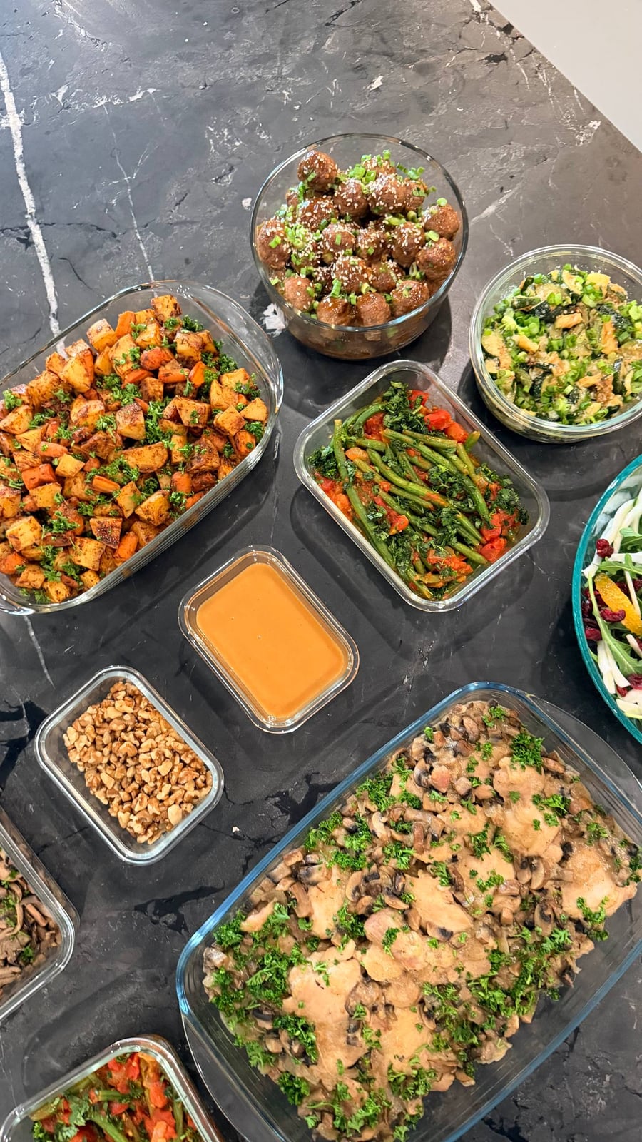 Teriyaki meatballs under sesame and scallion, sweet potatoes and green beans flanking them.