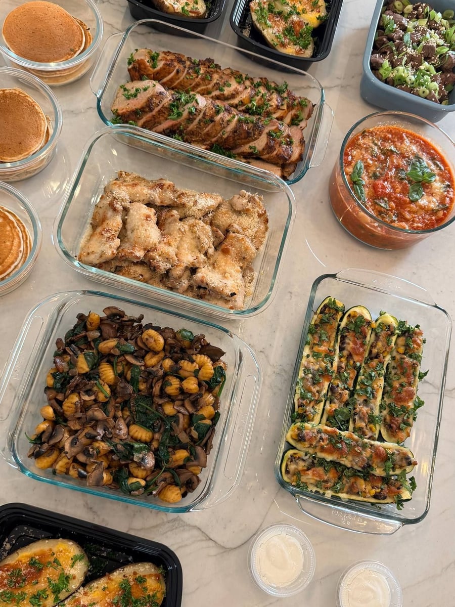 Zucchini boats packed with kidney beans, corn and mozzarella, browned in a long row.