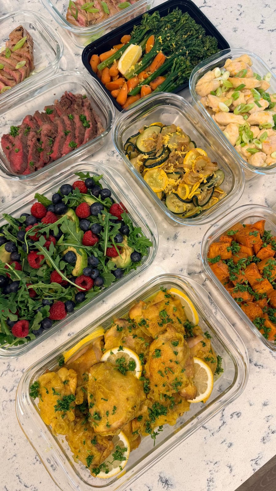 Saffron and turmeric turn the chicken thighs bright yellow, lemon wheels and parsley laid over them.