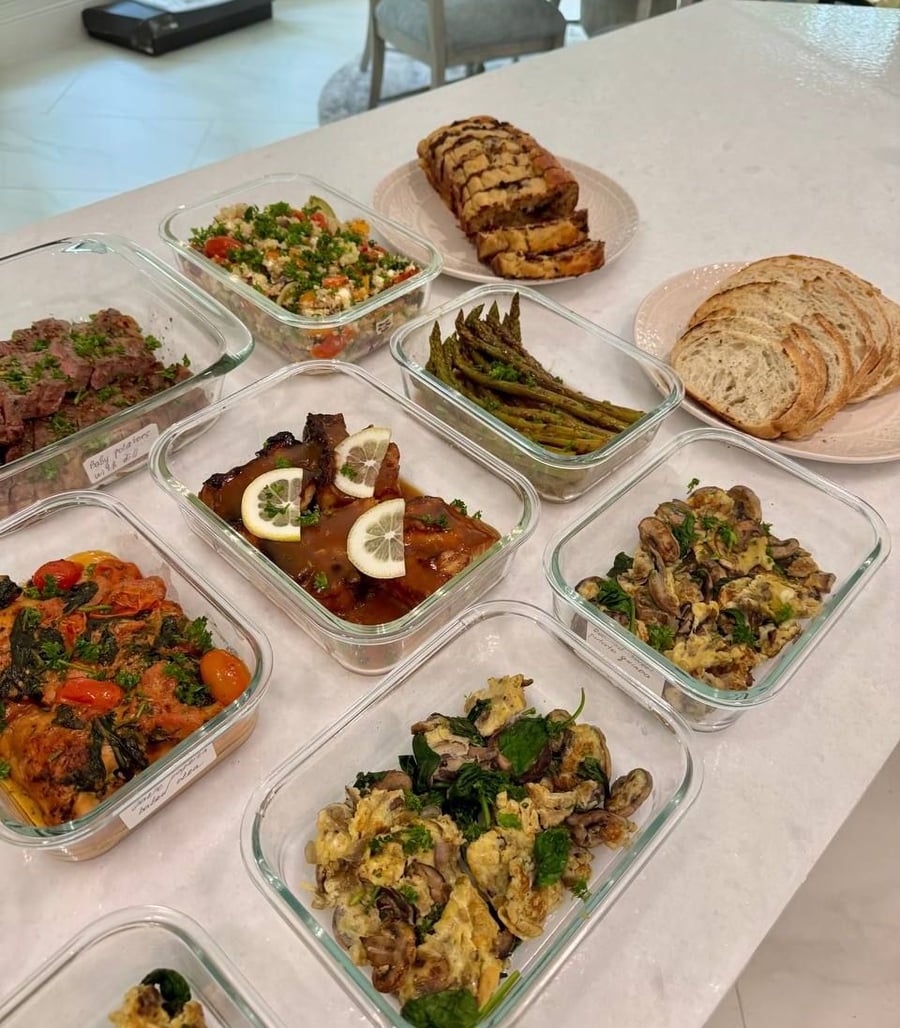 Fourteen containers in three rows, strip steak at the top and four egg scrambles along the bottom.