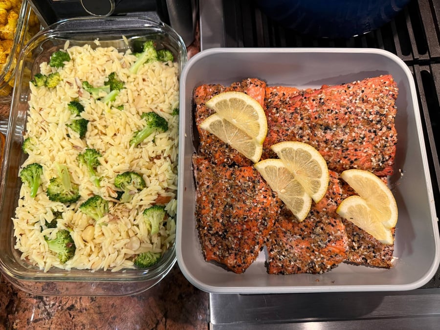 Sesame and poppy seed crust covers sockeye salmon, with lemon wedges over broccoli almond orzo.
