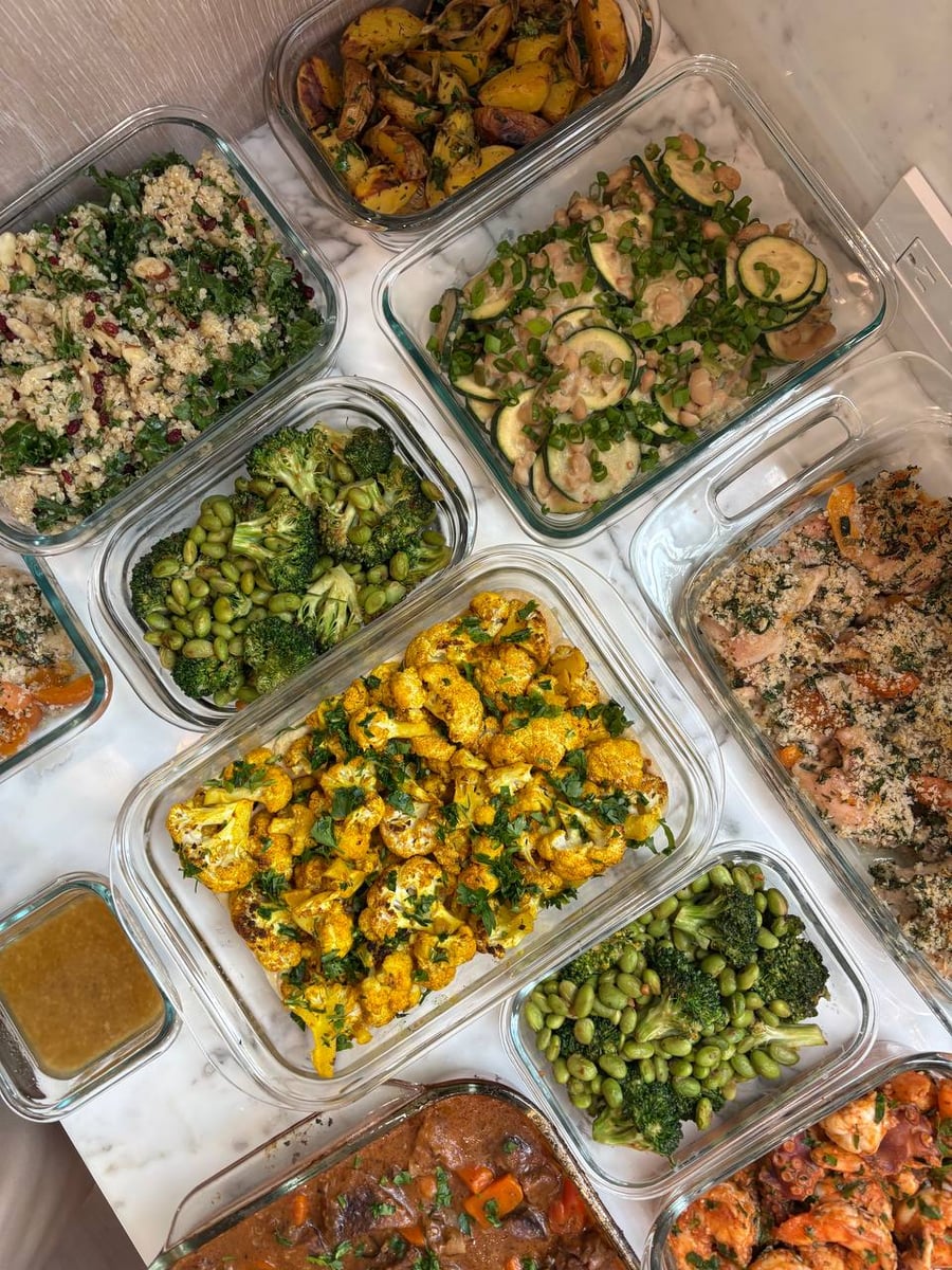 Cranberries dot kale and quinoa, broccoli with edamame stacked twice beside it, cauliflower centre.