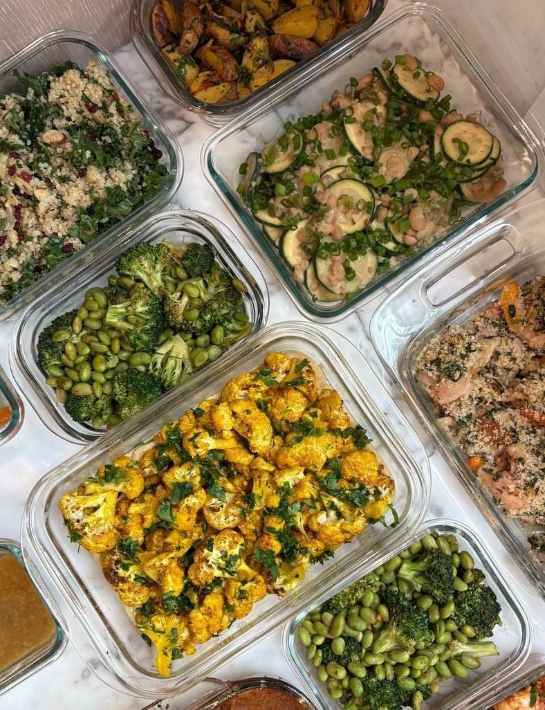 Halved baby potatoes and softened onion sit above quinoa with kale, white beans and zucchini.