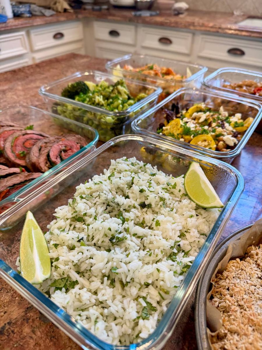 Chopped cilantro runs all through basmati rice with two lime wedges pressed into opposite corners.