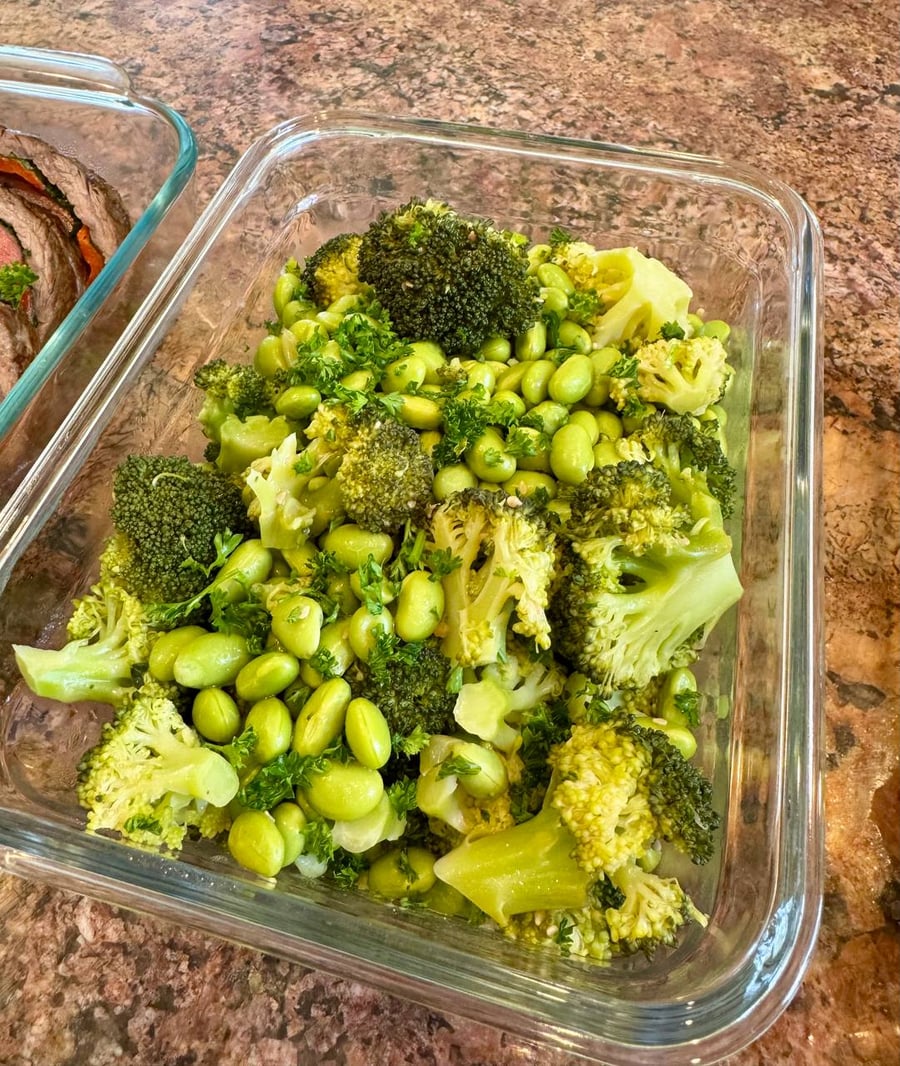 Parsley threads between broccoli florets and shelled edamame, everything still bright and squeaky.