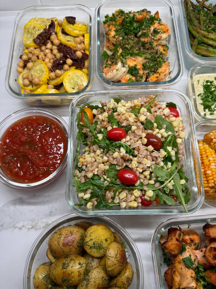 Chickpeas and sun-dried tomatoes sit among seared yellow squash coins, with tomato salsa and dill potatoes nearby.