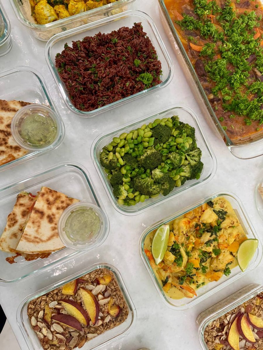 Two oat bakes in front, coconut shrimp and folded naan waiting at the back of the counter.