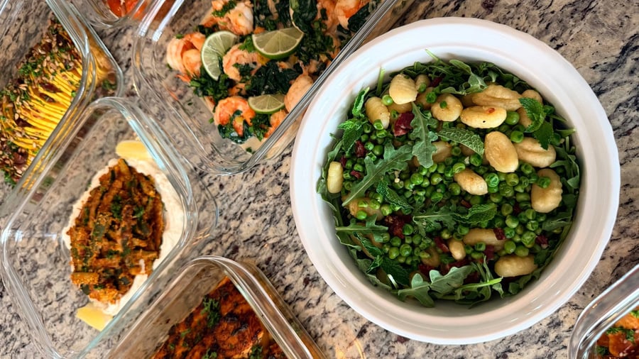 Eleven dishes ring the counter, from sumac salmon and pomodoro chicken to a bright pomegranate salad.