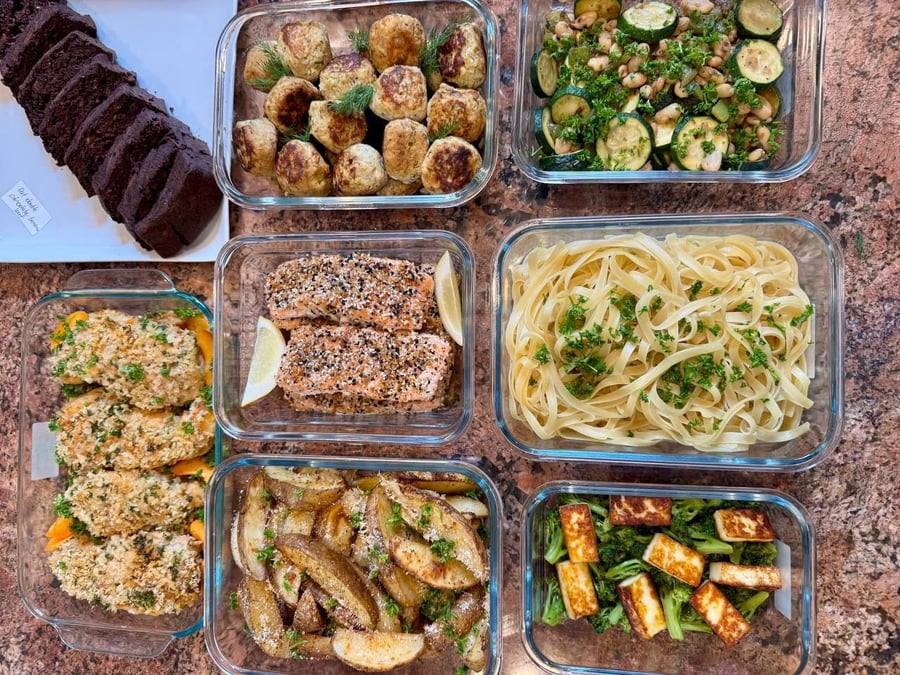 A diverse menu featuring crusted salmon and chicken, a trio of fresh dips, a savory paneer stir-fry, and a chocolate oat loaf to finish