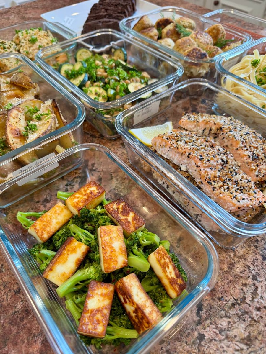Browned paneer cubes rest over broccoli, with everything bagel salmon and white beans behind them.