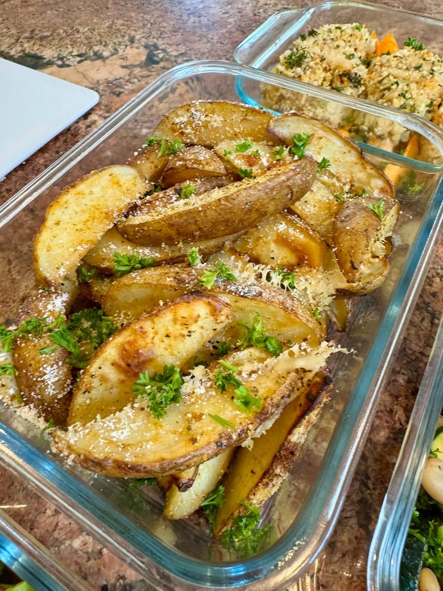 Skin-on wedges come out under grated parmesan and parsley, crisp edges catching the light.