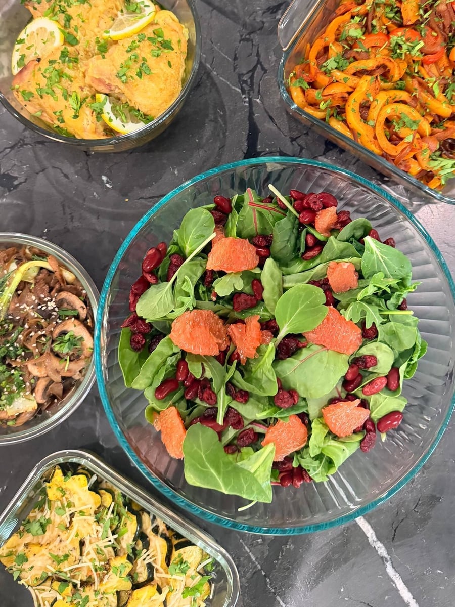 Pumpkin seeds and mint scatter across black lentils, roasted sweet potato cubes and halved red grapes on arugula.