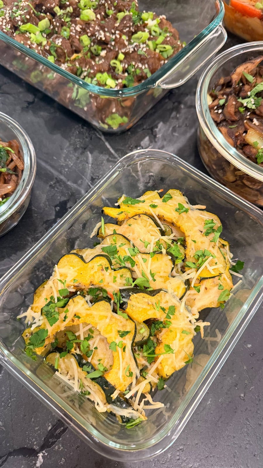 Cilantro brown rice, saffron turmeric chicken and seared paneer over heirloom tomatoes fill the middle of the counter.