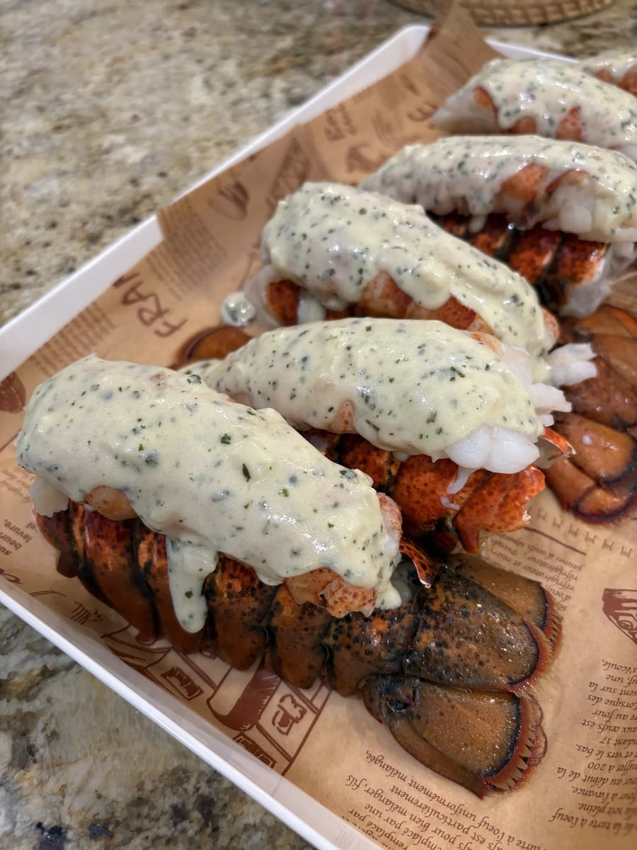 Butter-poached lobster tails finished with a herbed white wine beurre blanc.