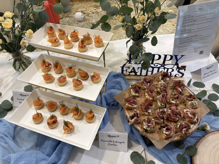 Wide Father's Day brunch spread with the Summer Weekend Brunch menu card and salmon tiers.