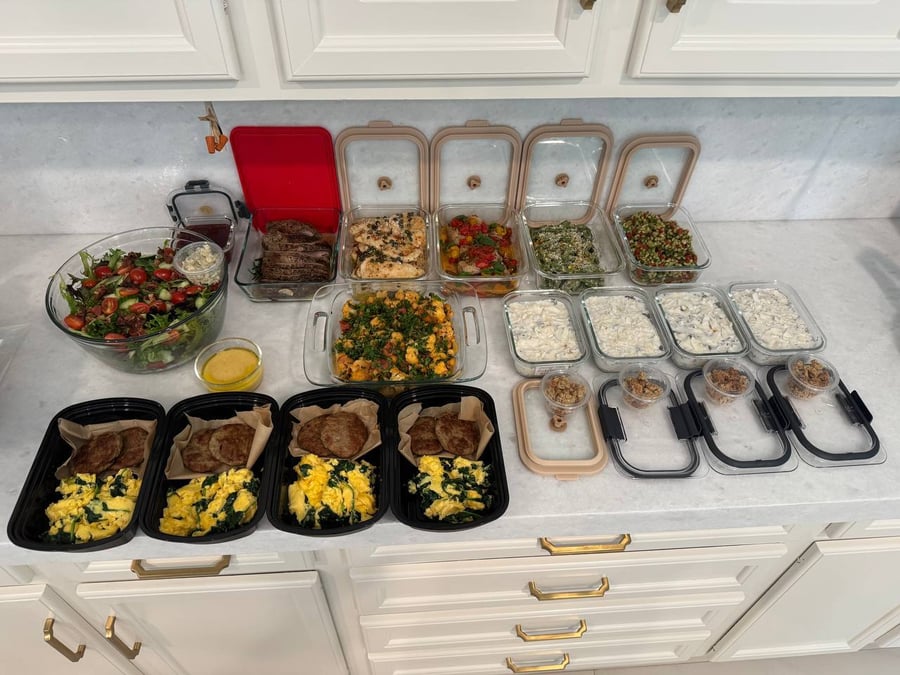 A variety of meal prep containers featuring roast beef, chicken piccata, cauliflower curry, chopped salad, and soft scrambles with maple chicken patties.