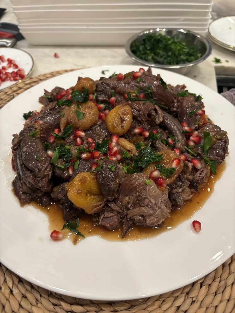 Pomegranate braised lamb shanks with dried stone fruit, pomegranate seeds, and fresh herbs.