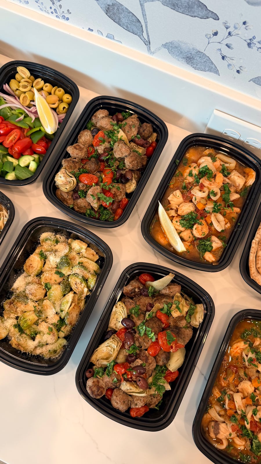 This assortment features savory Greek lean beef meatballs tossed with artichoke hearts and olives alongside a rich, fragrant Cioppino seafood stew.