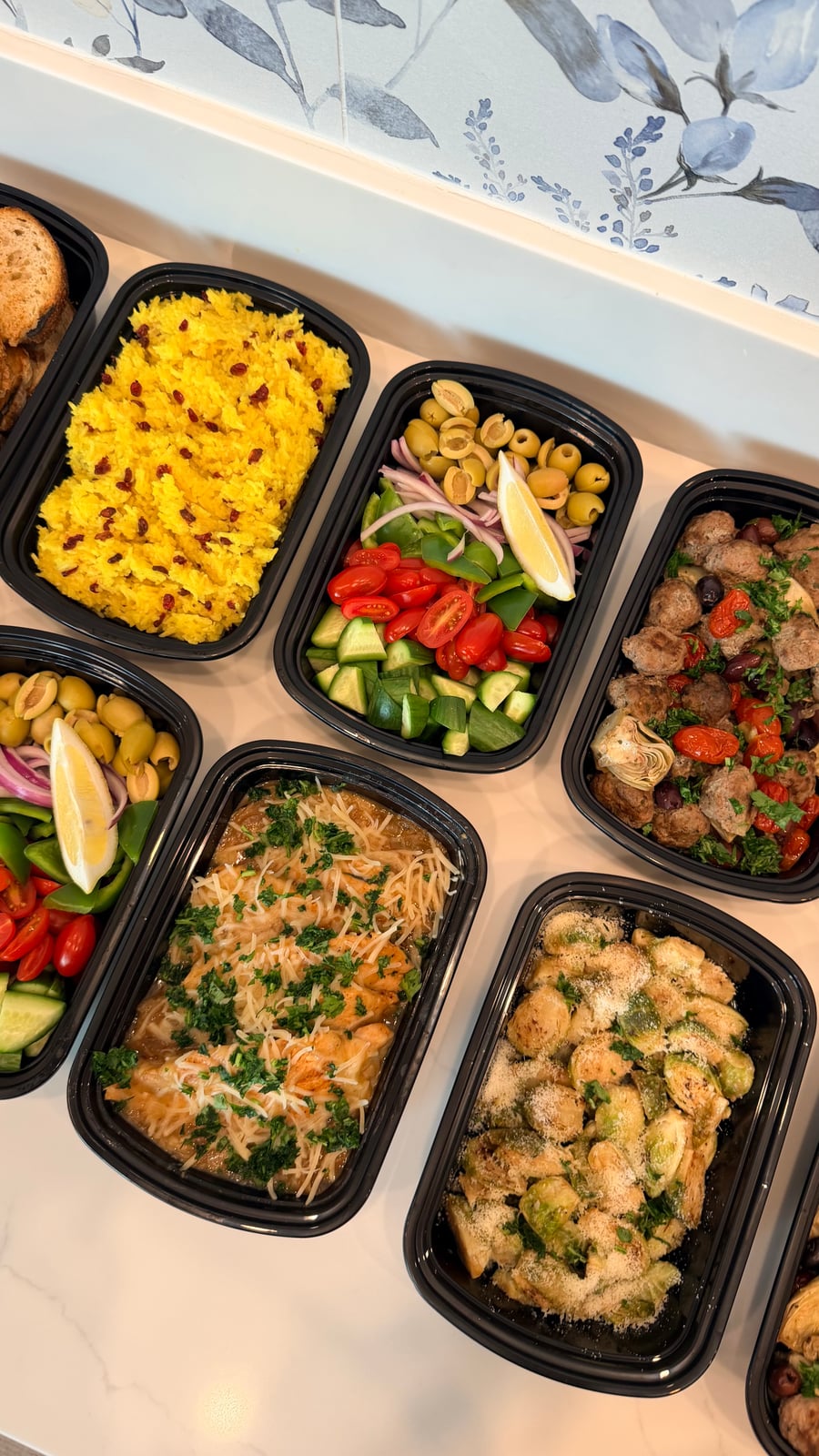 This variety of dishes features French onion chicken,Greek beef meatballs, saffron rice, roasted Brussels sprouts, and Greek salad.