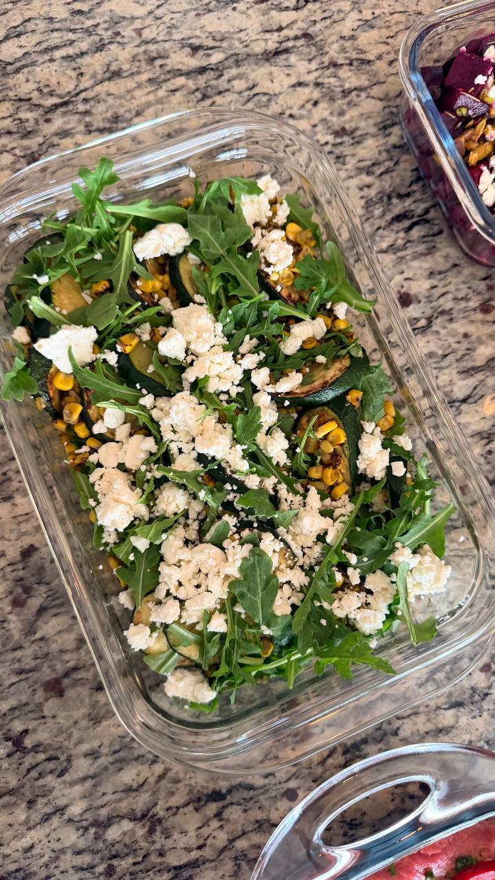 Charred corn and zucchini salad with peppery arugula and crumbled feta, highlighting fresh ingredients for healthy home-cooked meals.