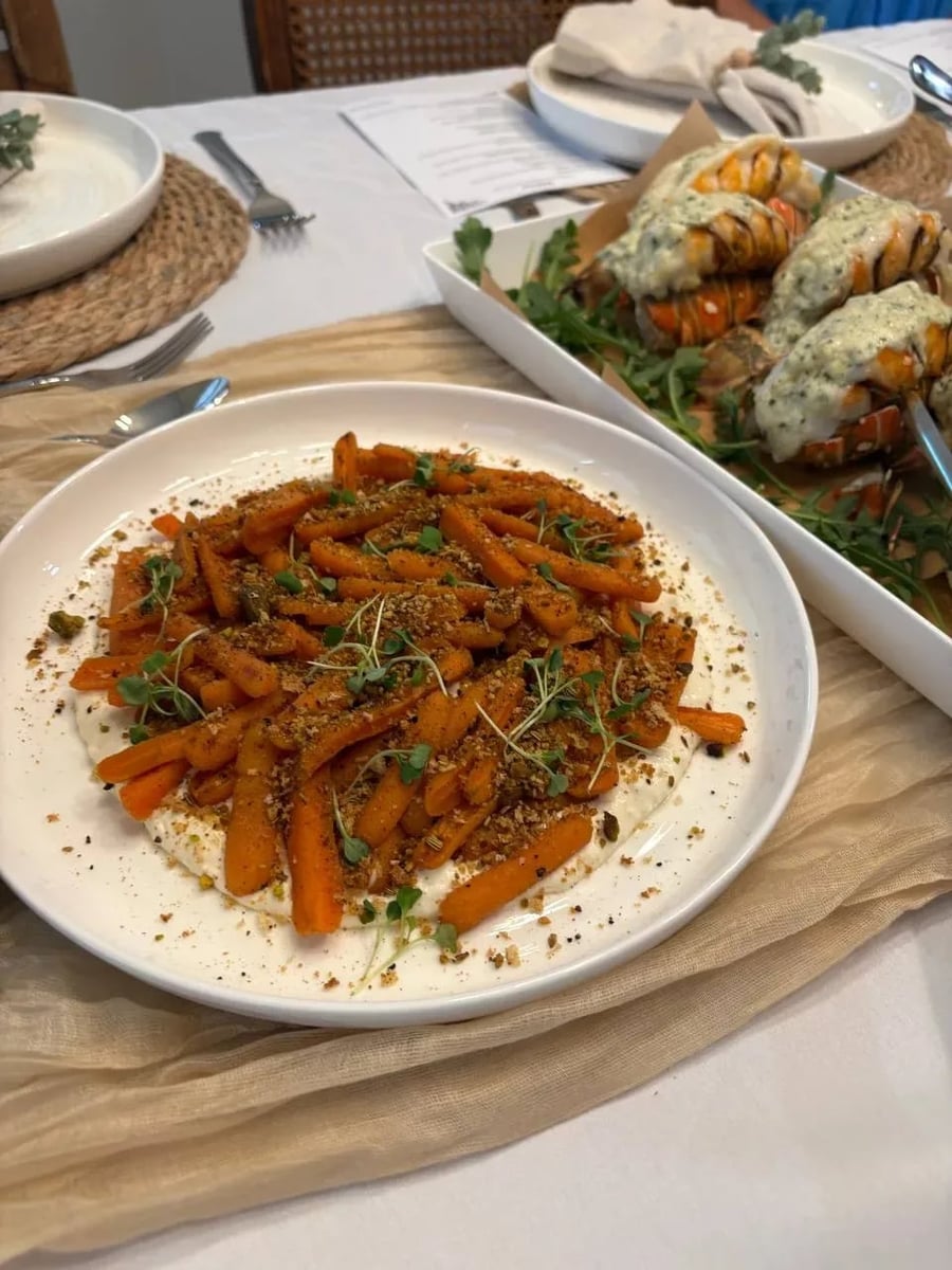 Honey-roasted baby carrots with pistachio-fennel dukkah and microgreens on a bed of whipped feta.