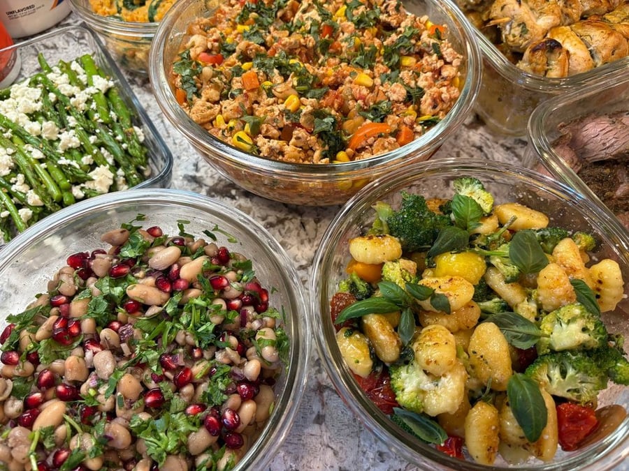 Assortment of meal prep dishes including salads, gnocchi, and ground meat