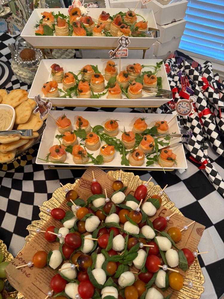 Variety of appetizers including salmon tarts and mozzarella skewers.